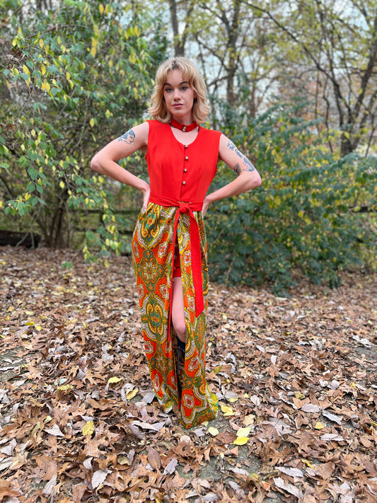 Front view on the model with hands on hips, paisley skirt with buttons down the front and the matching belt at the waist