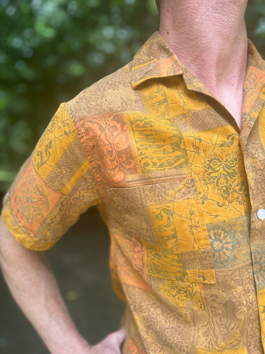 Close-up of the collar, sleeve and chest pocket on the model showing the botanical print