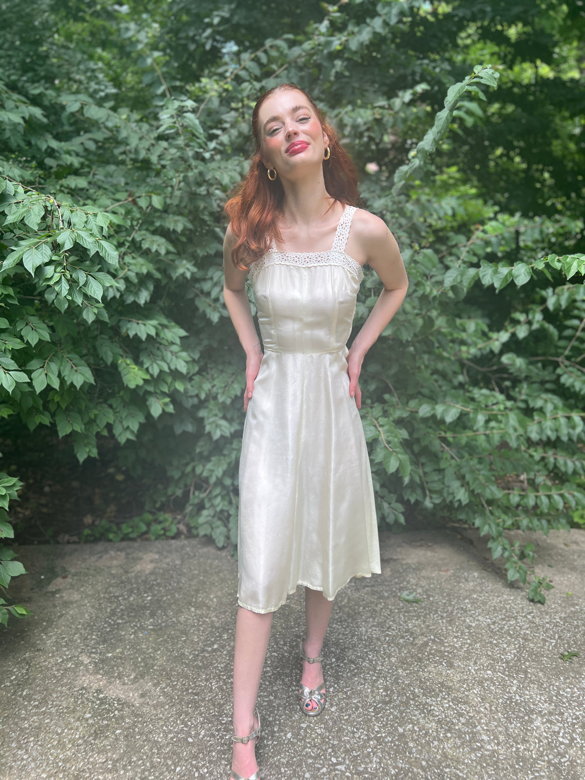 Front view on the model, hands on hips, showing the bodice and skirt