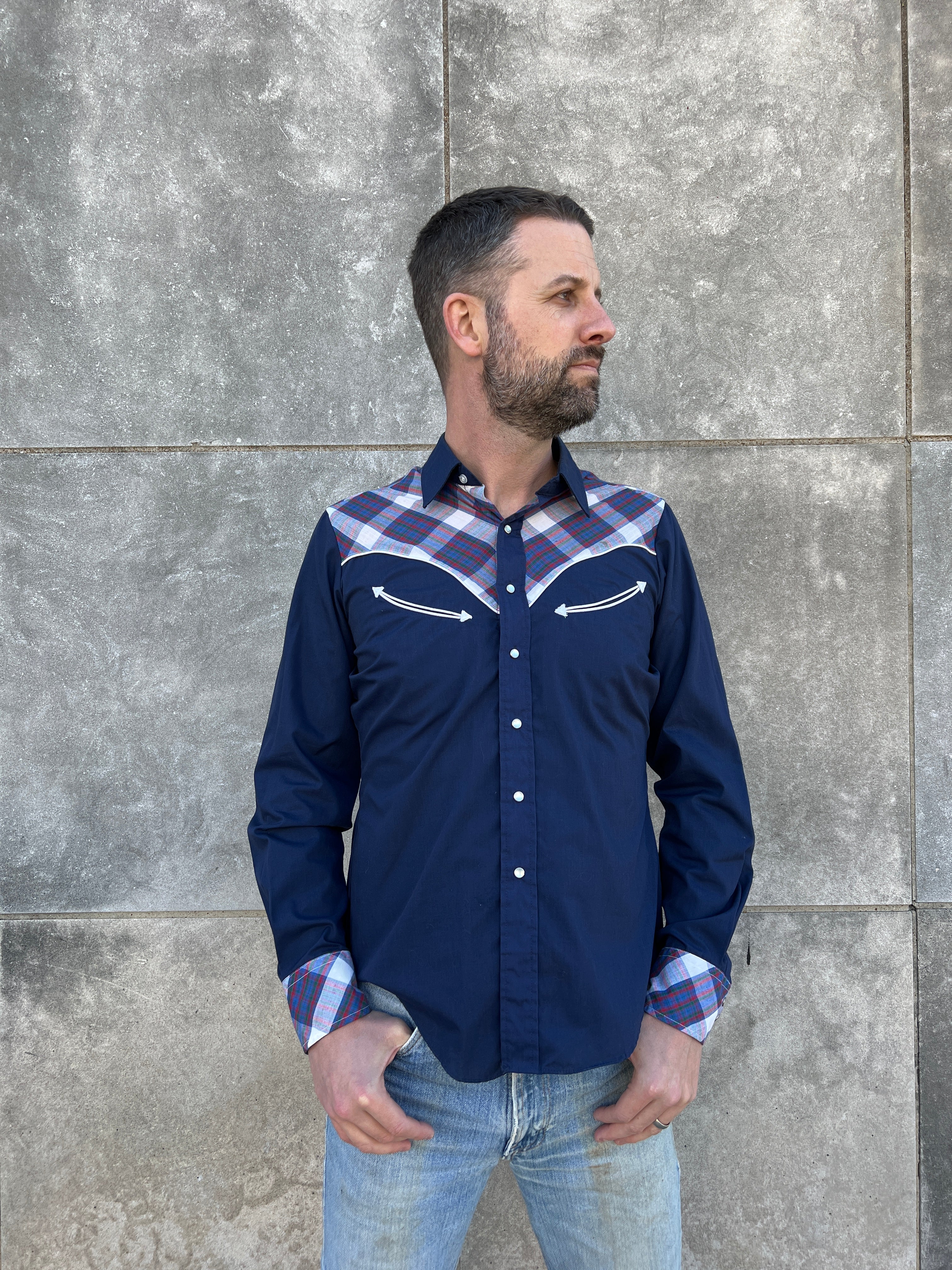 Man in Blue and White Plaid Shirt and Denim Jeans Standing on