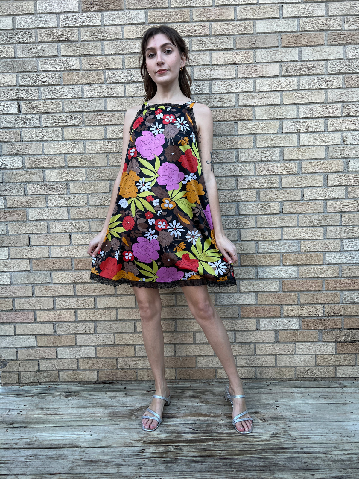 Front view on the model standing, showing the lace trimmed hem