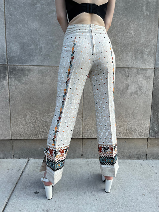 Back view on the model showing the diamond pattern, center back zipper and the hem borders