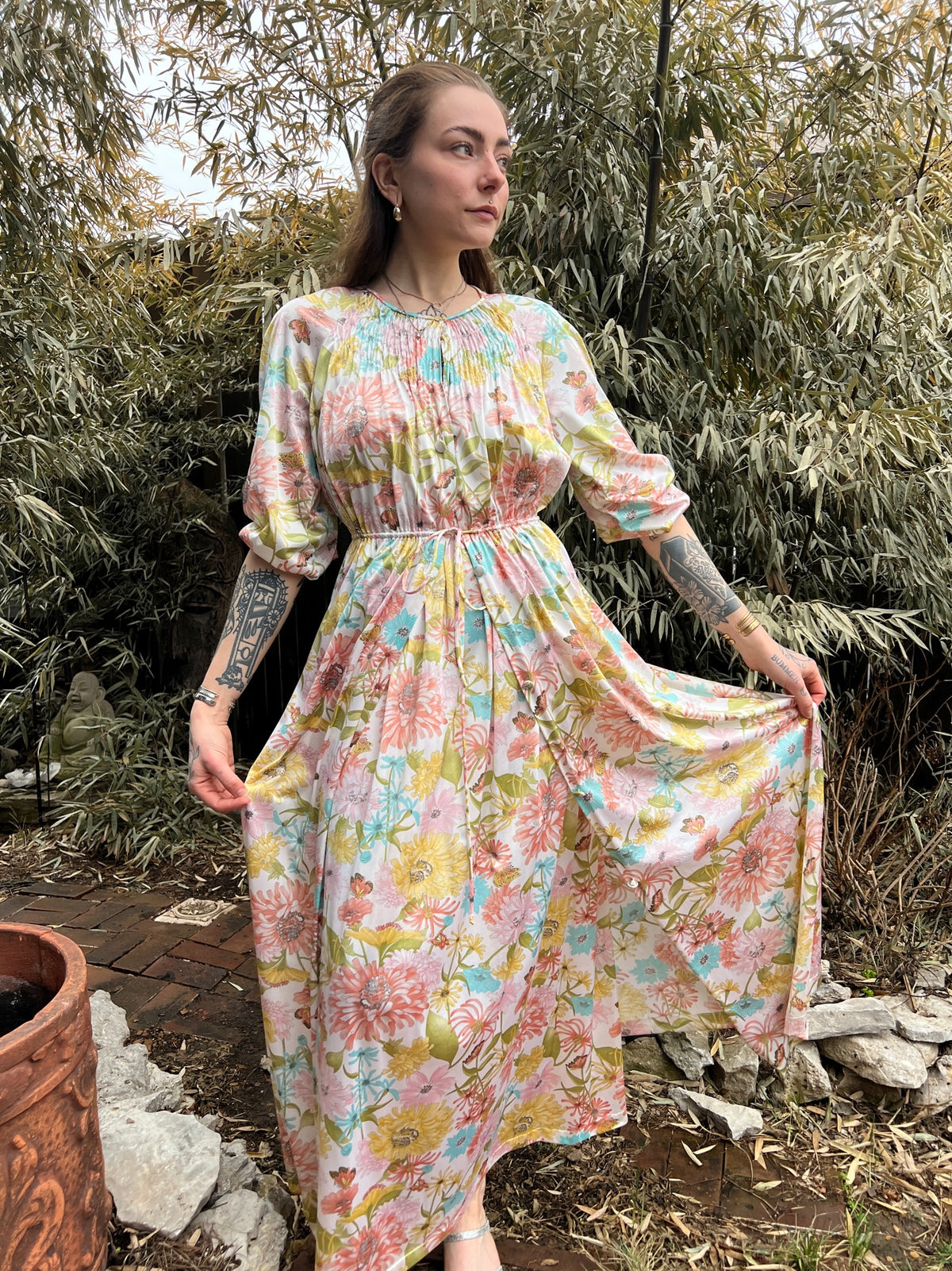 Angled front view of the robe on the model, tied at the waist with the skirt swinging open