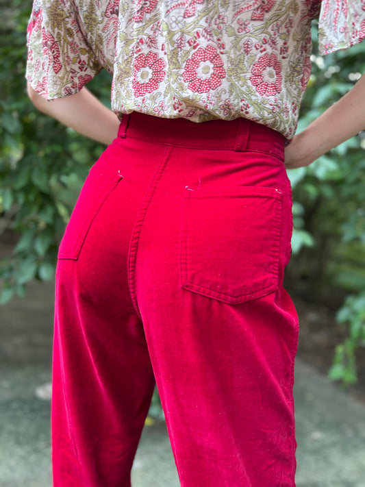 Close-up of the back waistband and a patch pocket on the cranberry red velour pants