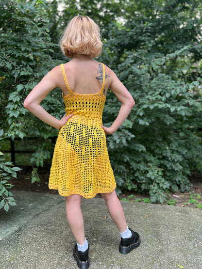 Back view on the model showing the straps, bodice and flared skirt