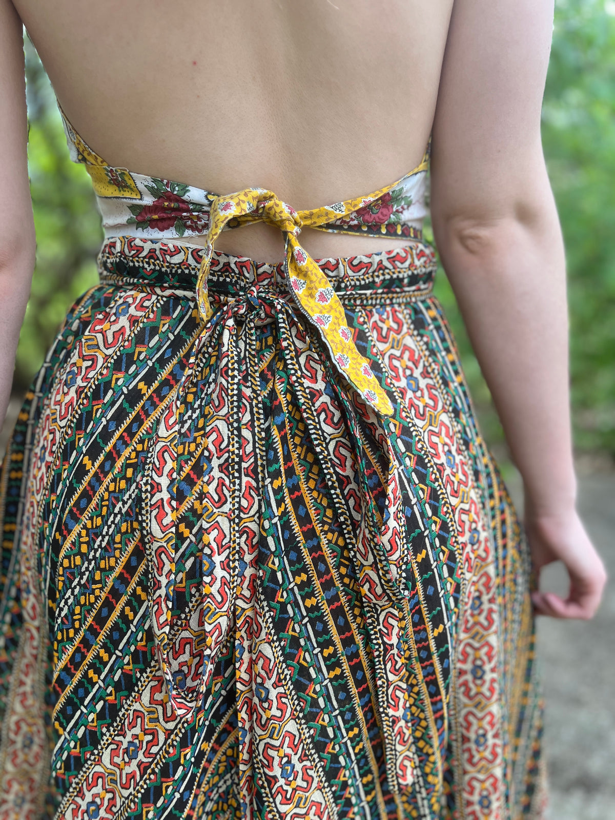 Close-up of the tied self belt at the back waist and the print panels