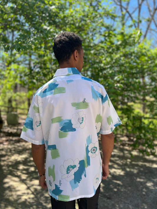 Back view on the model showing the collar and blue and green floral print