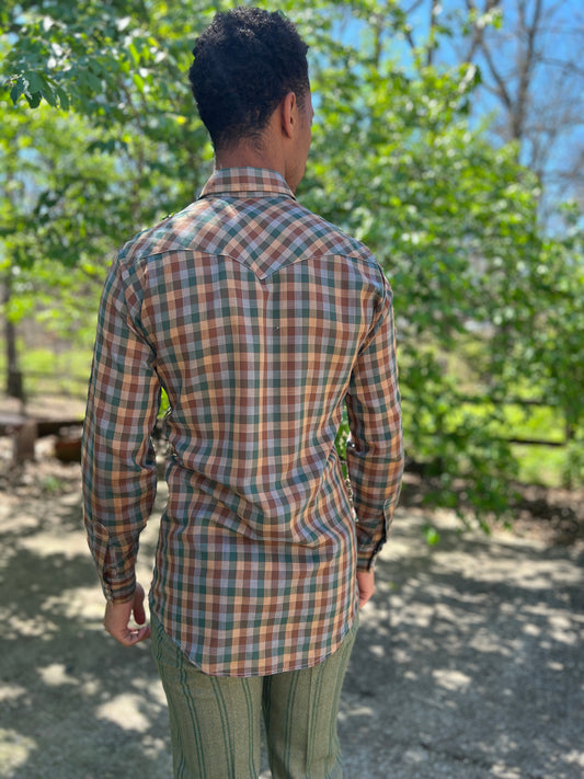 Back view of a brown, tan and green gingham western shirt with a yoke, worn by a model