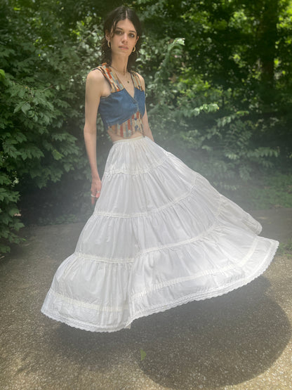 Front view on the model with the full skirt swinging out, showing the tiers and the eyelet-trimmed hem
