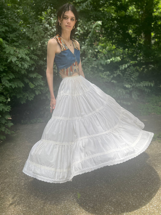 Front view on the model with the full skirt swinging out, showing the tiers and the eyelet-trimmed hem