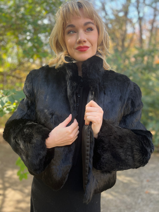 Black rabbit fur jacket with a Nehru style collar, worn open by a model
