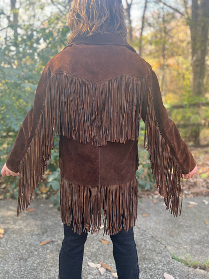 Back view on the model showing the fringed yoke, long fringe down the sleeves and fringed hem
