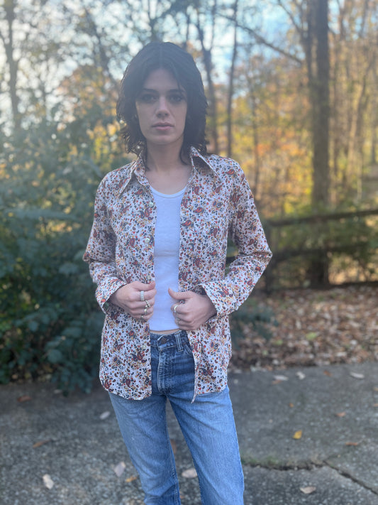 Red and blue paisley long sleeve shirt with a collar, worn open over a tank top by a model