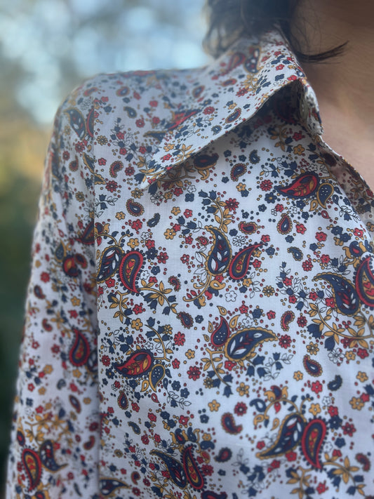 Close-up of the collar and shoulder showing the red and blue paisley print