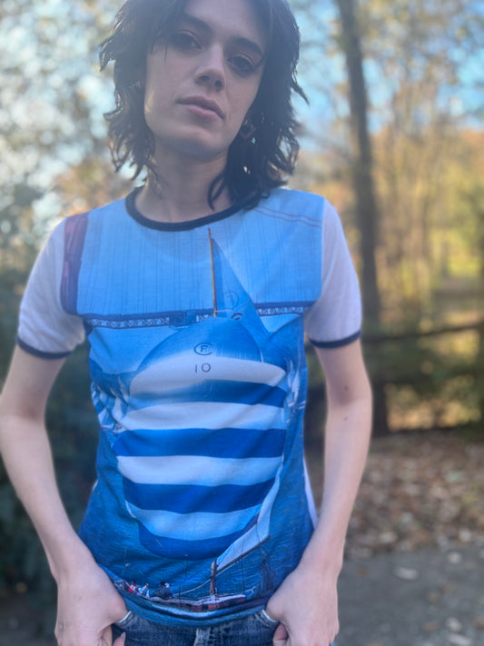 Close-up of the sailboat photo print on the front, with the neckline and sleeve trim