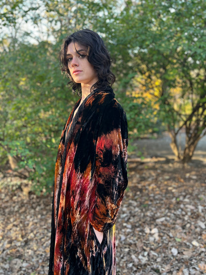 Close-up side view on the model of the sleeve and the open front edge of the coat