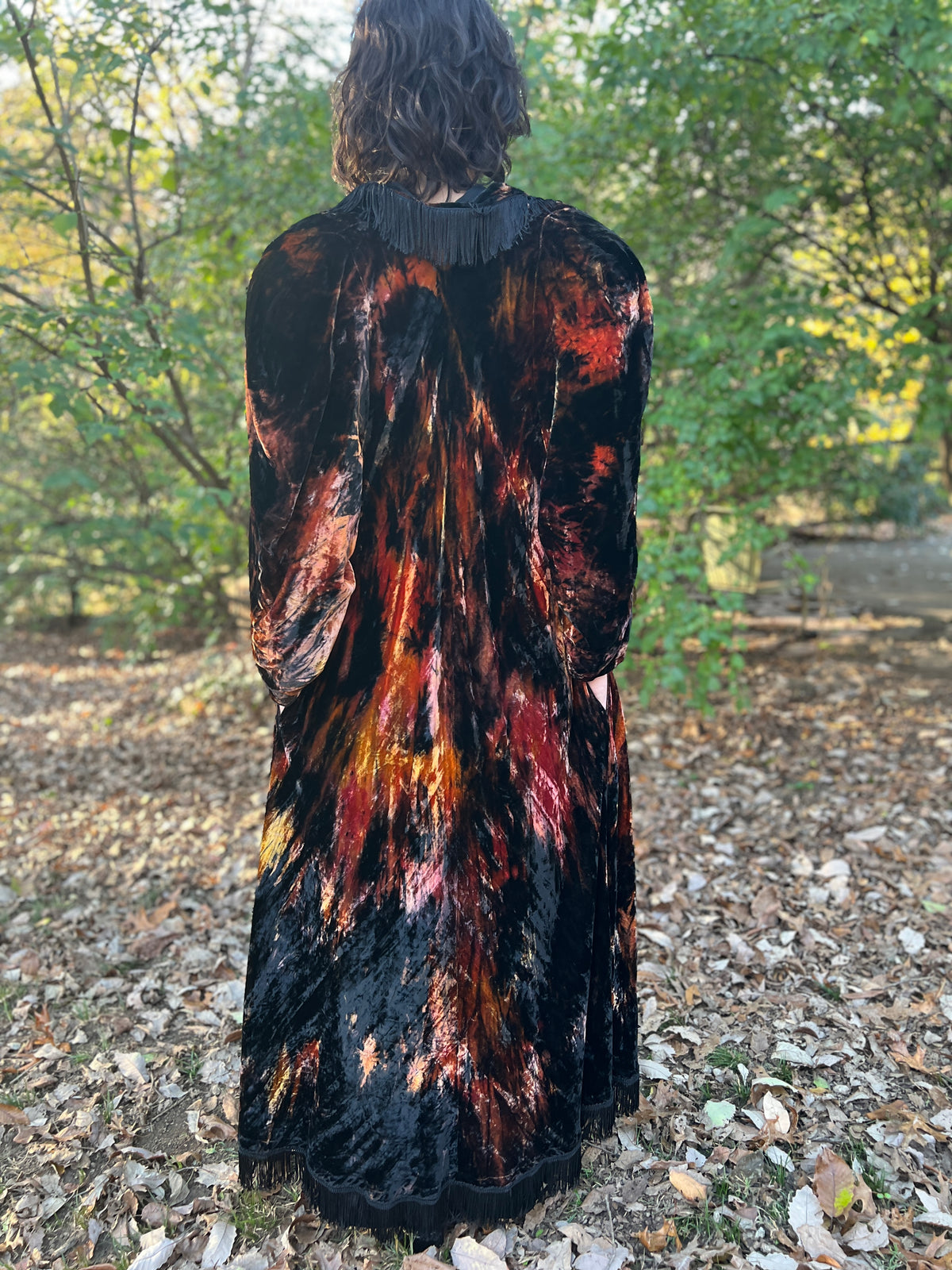 Back view on the model showing the fringe across the back of the collar and the streaked velvet