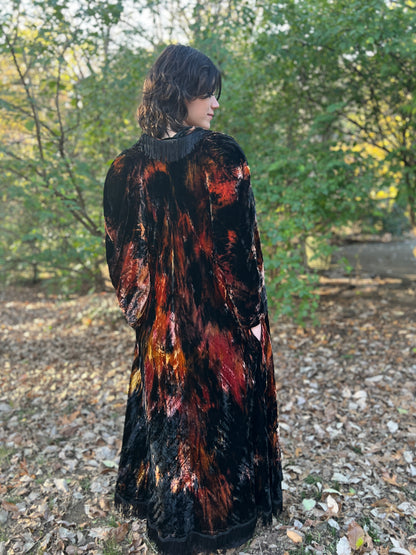 Back three-quarter view on the model, head turned, showing the fringed collar and full-length back