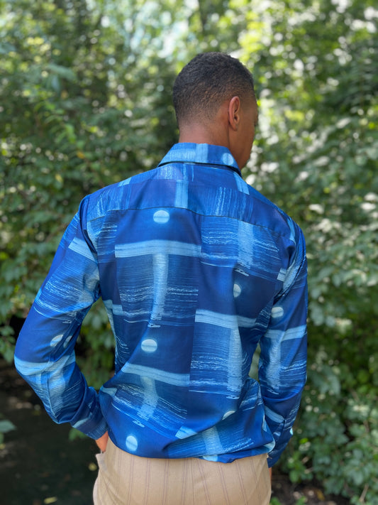 Back view of a blue long sleeve shirt with a full moon pattern and collar, worn by a model