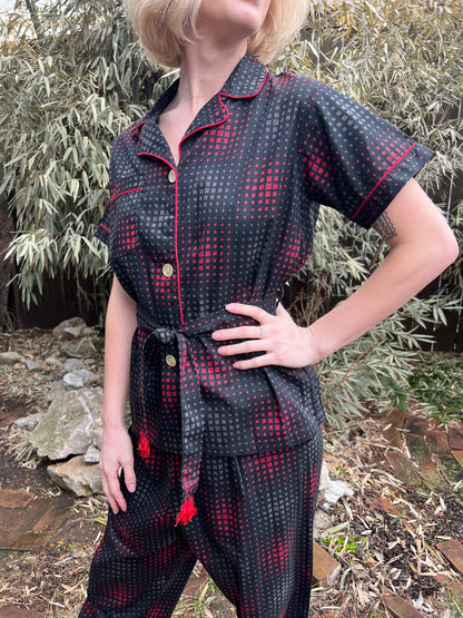 Angled view of the pajama top on the model showing the piped collar, buttons, pocket and tied belt