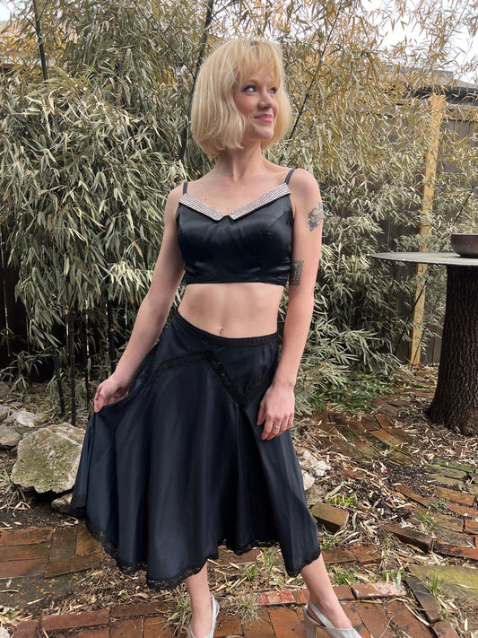 Black rayon half slip with lace insets at the hips, worn as a skirt by a model