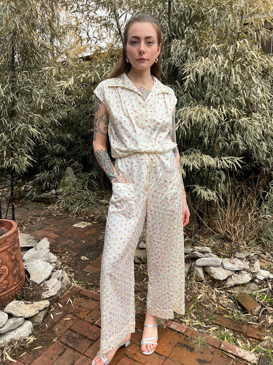 Pearl satin pajama set with a small floral pattern, short-sleeve collared top and pants, worn by a model