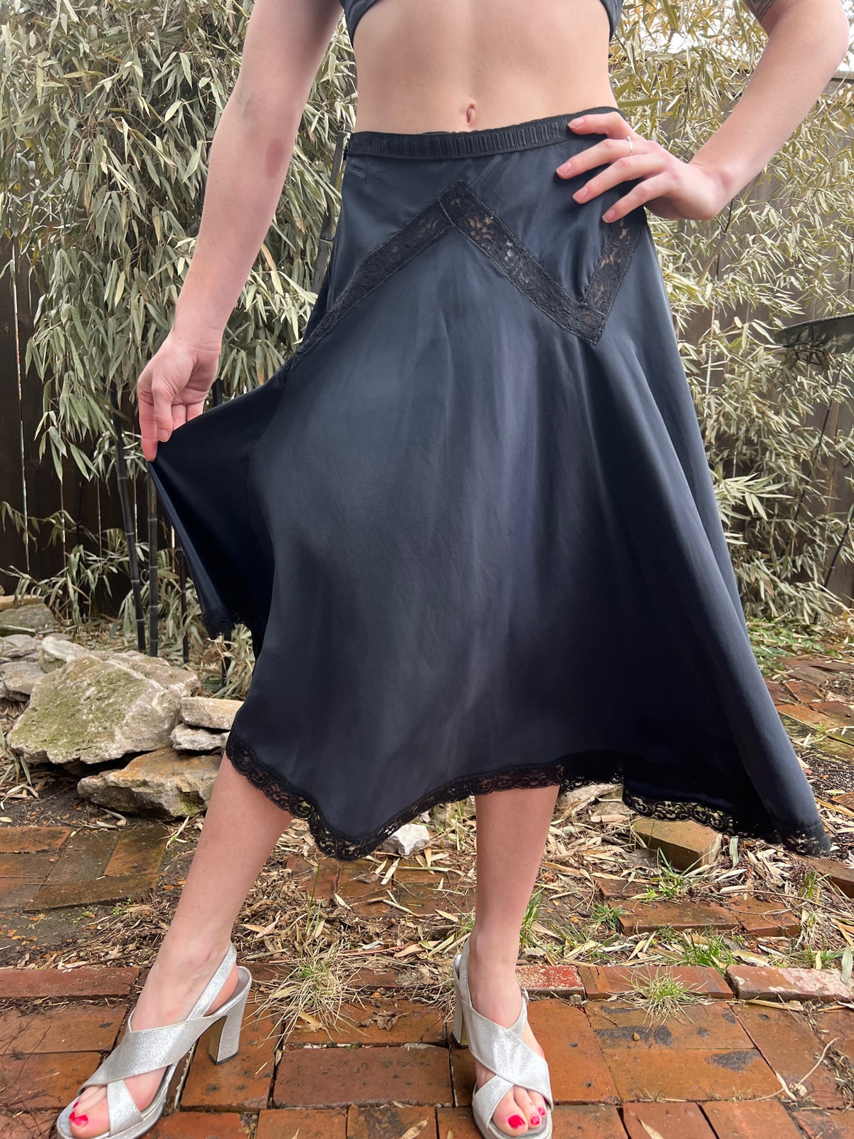 Close-up of the slip on the model showing the lace at the hip and the waistband