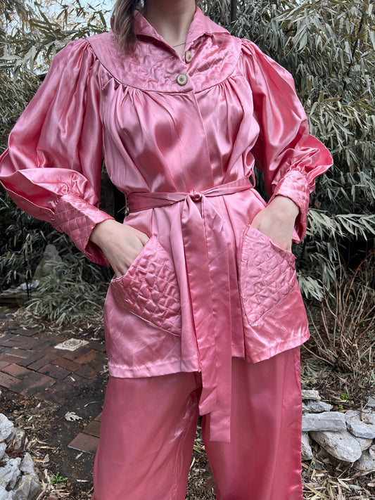 Close-up of the pajama top on the model showing the quilted yoke, quilted cuffs, buttons and tied belt