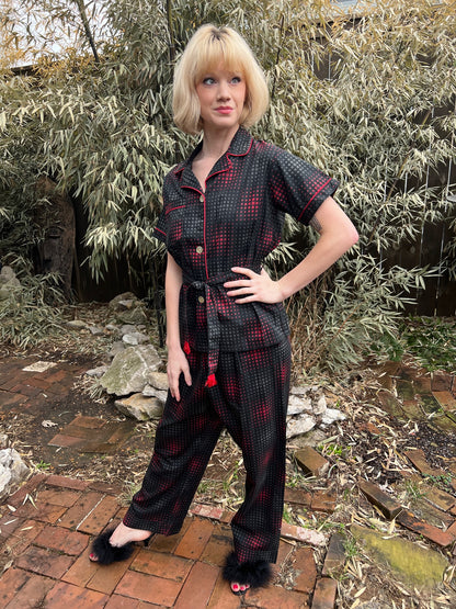 Black, red and gray cotton pajama set with red piping, short-sleeve top, fringed belt and straight-leg pants, on a model