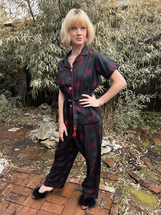 Black, red and gray cotton pajama set with red piping, short-sleeve top, fringed belt and straight-leg pants, on a model
