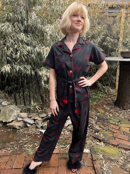 Full-length front view of the pajama set on the model, hand on hip, showing the top, belt and pants