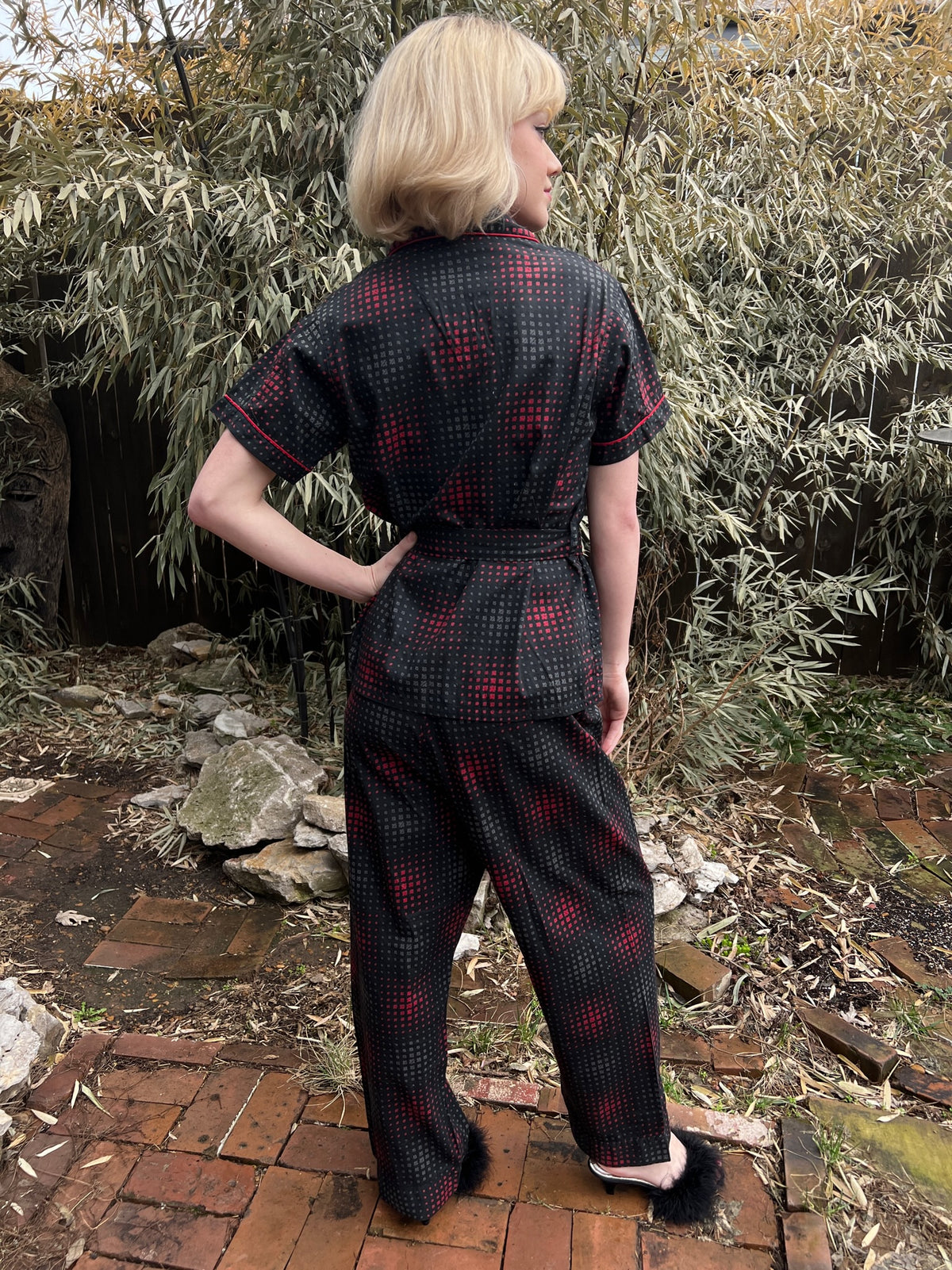Back view on the model showing the pajama top, belt and straight-leg pants