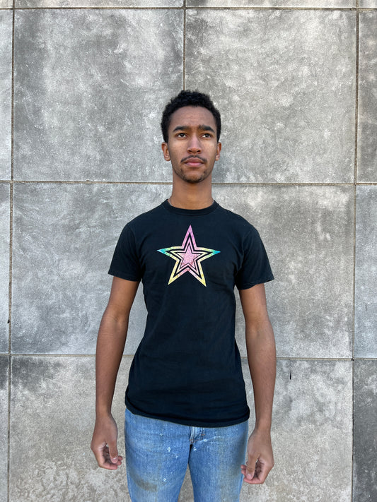 Black t-shirt with an iron-on glitter star on the chest, worn by a model