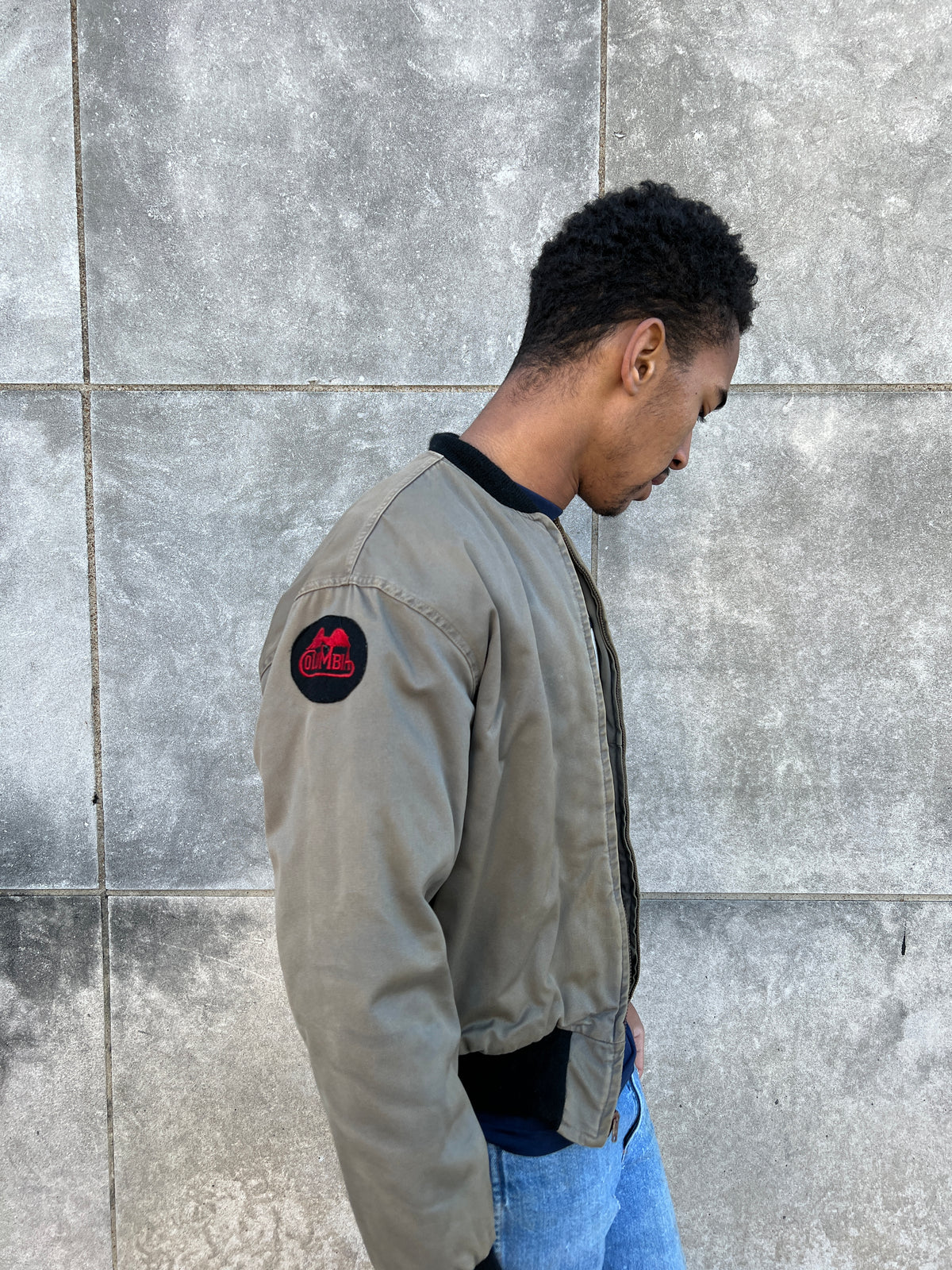 Side view on the model showing a round Columbia patch on the upper sleeve