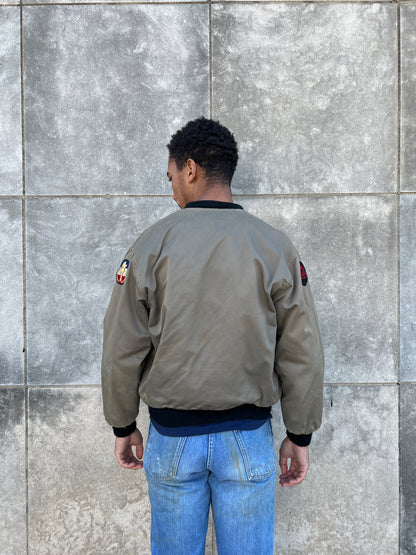 Back view on the model showing the back with a patch on each upper sleeve and the knit waistband