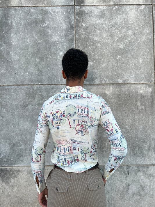Back view on the model showing the cafe scene print across the back and sleeves