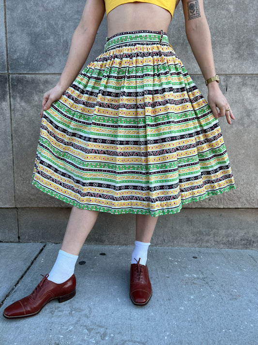 Gathered yellow and green striped skirt, worn by a model