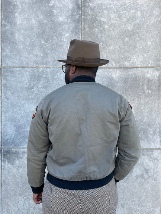 Back view on the model showing the back, knit waistband and a patch on each upper sleeve