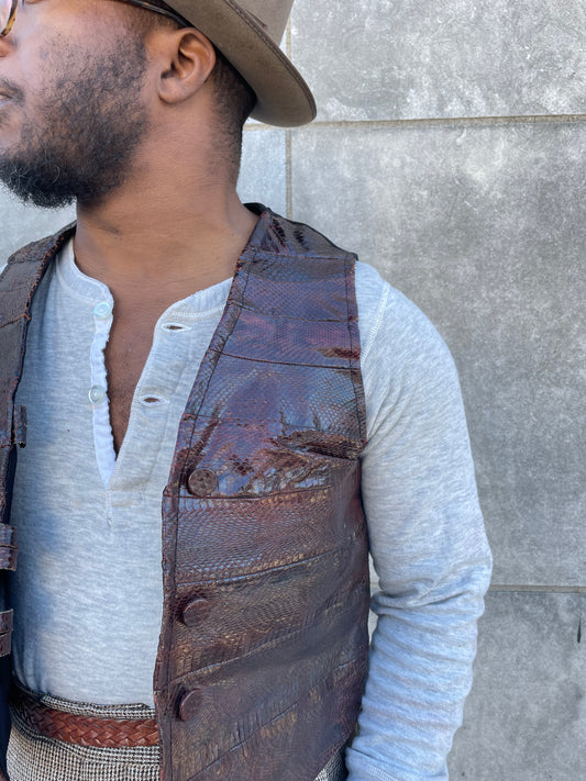 Close-up of the snake skin and covered buttons on the front of the vest on the model