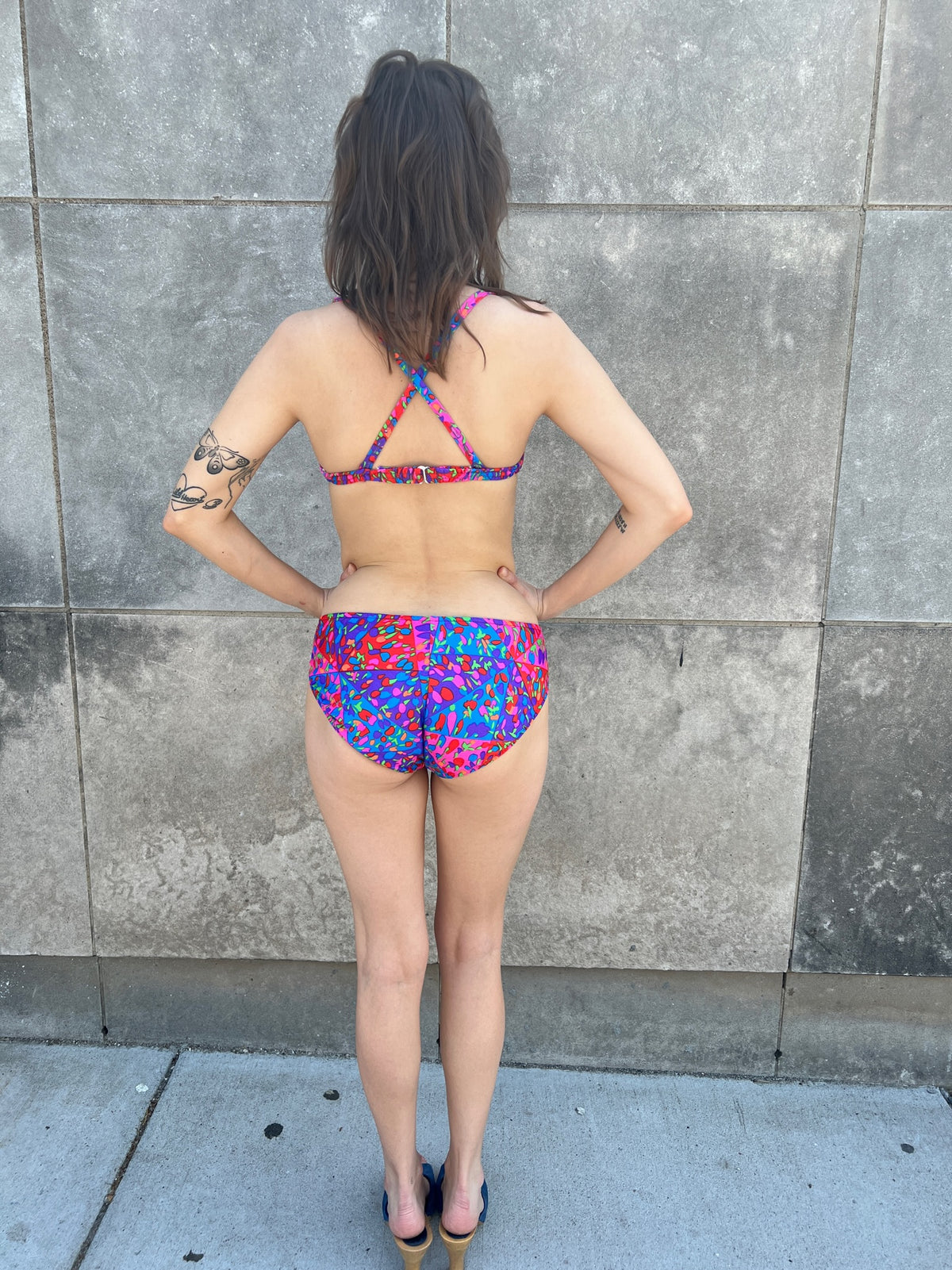 Back view of the bikini on the model showing the back straps, clasp and briefs