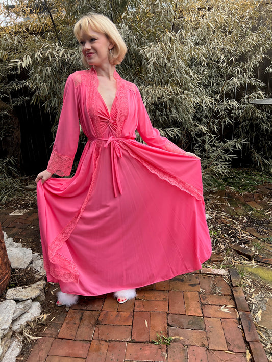 Hot pink robe tied at the waist over the gown, skirt held out, worn by a model