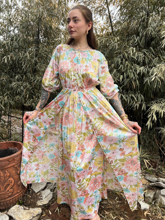 Tan floral nylon robe with a belted waist, worn by a model holding the skirt out
